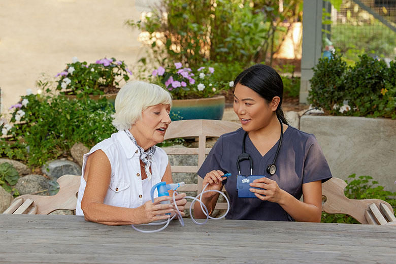 NebulizerAsianClinicianWhiteFemaleSittingOutsidePortableNebulizerPariTrekWithBatteryCharger4745LCS13